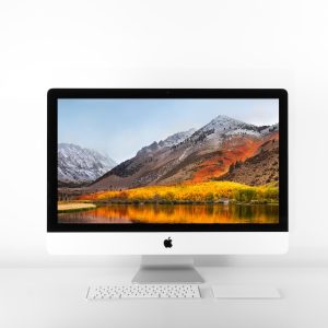 silver iMac and Magic keyboard on white surface